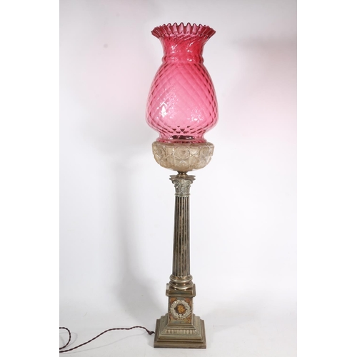 384 - Victorian silver plated Corinthian column oil lamp base, the cranberry glass shade over clear cut gl... 