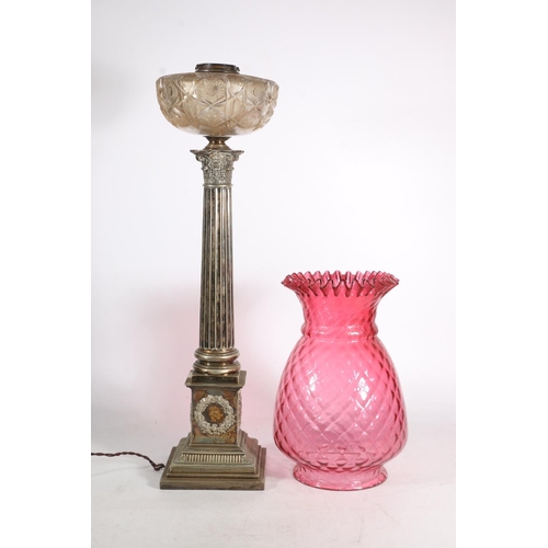 384 - Victorian silver plated Corinthian column oil lamp base, the cranberry glass shade over clear cut gl... 