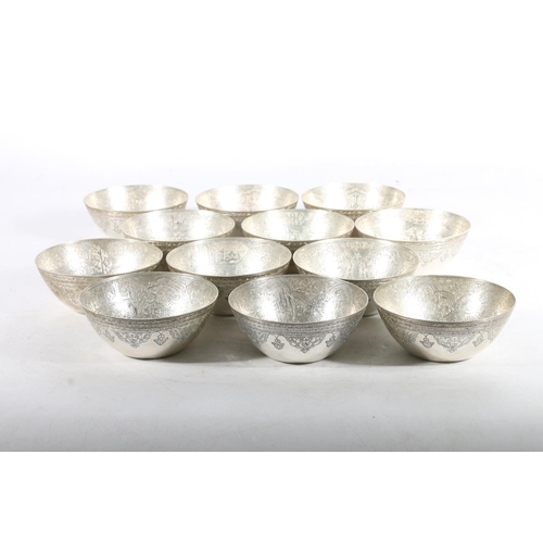 62 - Set of twelve Egyptian silver bowls, c1920s, the bowls finely chase engraved with Arabic lettering, ... 