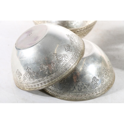 62 - Set of twelve Egyptian silver bowls, c1920s, the bowls finely chase engraved with Arabic lettering, ... 