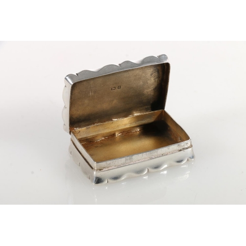 65 - Edward VII silver snuff box of rectangular form with shaped edges, the body engraved with scrolled a... 