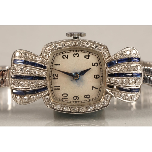 114 - Ladies platinum and sapphire cocktail watch, numbered dial surrounded by small diamonds, with four v... 