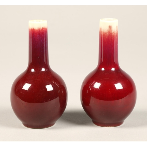 222 - Sang De Boeuf, pair of red bottle shaped chinese vases, 10 cm high