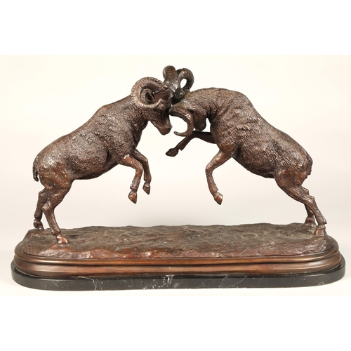 245 - Twentieth century figure of two rams fighting, on marble base, signed T R, 75cm long,47 cm high.