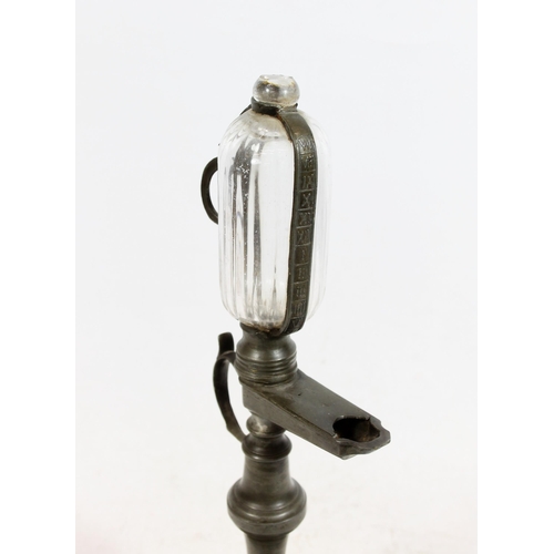 381 - Continental pewter whale oil lamp clock, 19th century, the glass reservoir enclosed within pewter ho... 