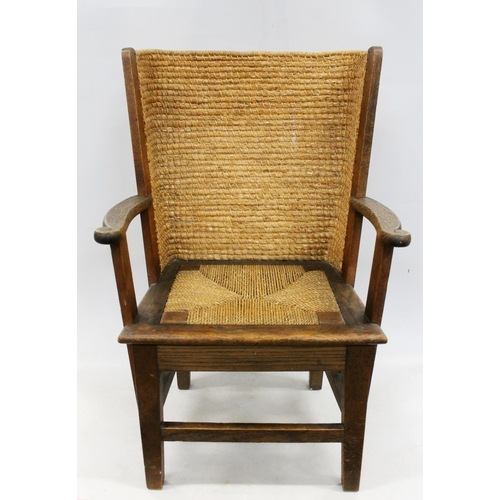 598 - Early 20th century oak framed Orkney chair, the woven back with scrolled arms and drop in woven seat... 