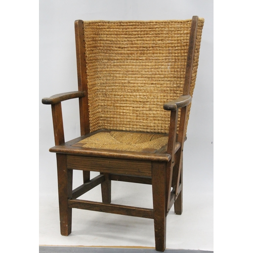 598 - Early 20th century oak framed Orkney chair, the woven back with scrolled arms and drop in woven seat... 