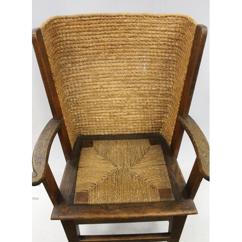 598 - Early 20th century oak framed Orkney chair, the woven back with scrolled arms and drop in woven seat... 