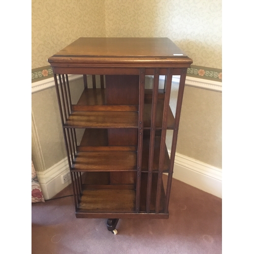 610 - Early 20th century oak revolving bookcase of typical form, 114cm tall.