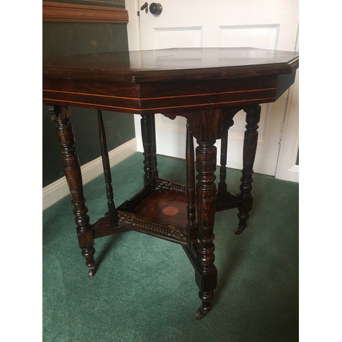 615 - Victorian rosewood and string inlaid octagonal centre table raised on eight turned supports united b... 