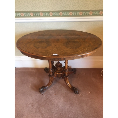 616 - Victorian walnut and inlaid oval centre table raised on four turned columns upon quadripartite base ... 