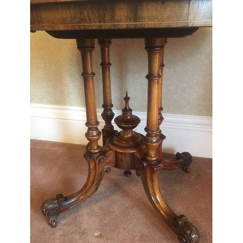 616 - Victorian walnut and inlaid oval centre table raised on four turned columns upon quadripartite base ... 