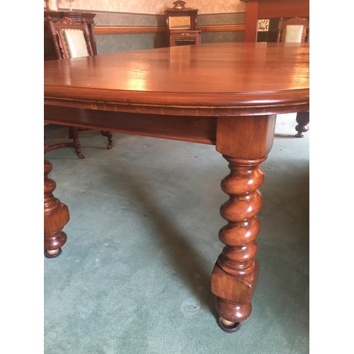 617 - Victorian mahogany telescopic extending dining table raised on large barley twist supports capped wi... 