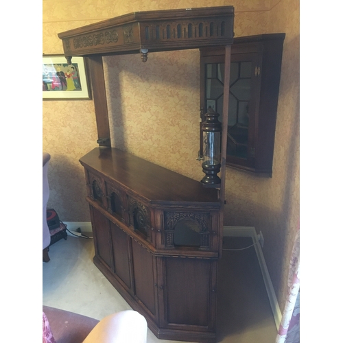 618 - 20th century carved oak corner bar unit with five panel front, the lower frieze with bullseye and pl... 