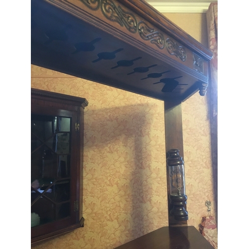 618 - 20th century carved oak corner bar unit with five panel front, the lower frieze with bullseye and pl... 