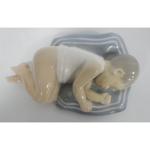 223 - Royal Copenhagen porcelain figure in the form of a sleeping child, shape no. 4496, with initials TL ... 