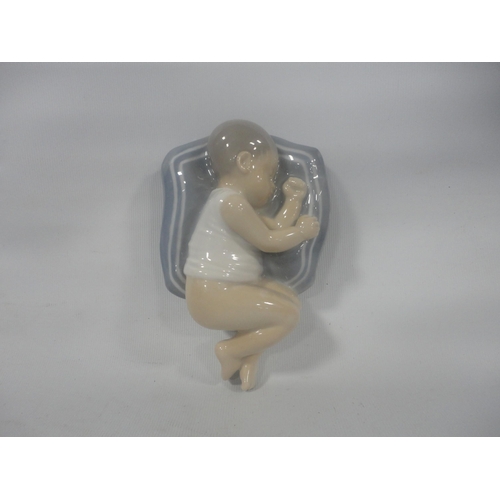 223 - Royal Copenhagen porcelain figure in the form of a sleeping child, shape no. 4496, with initials TL ... 