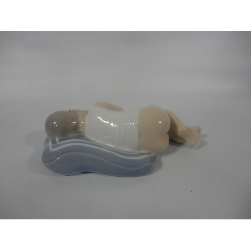 223 - Royal Copenhagen porcelain figure in the form of a sleeping child, shape no. 4496, with initials TL ... 