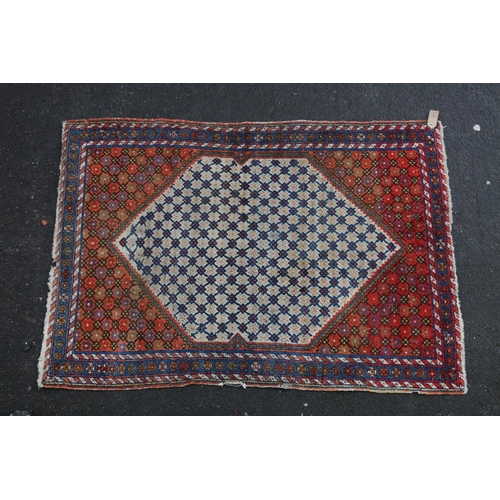 621 - Kilim style rug, the cream background lozenge shaped field bordered by a conforming red ground withi... 