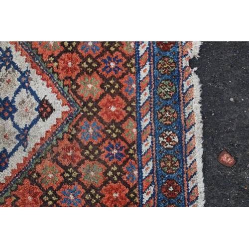 621 - Kilim style rug, the cream background lozenge shaped field bordered by a conforming red ground withi... 