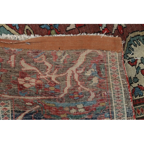 625 - Serapi carpet rug, decorated throughout with floral and foliate designs, the madder field within fol... 