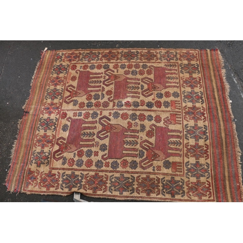 626 - Caucasian carpet rug, the beige ground decorated with geometric goats and flowers within a geometric... 