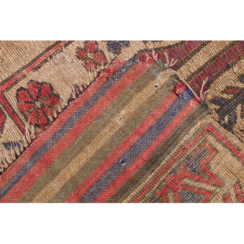 626 - Caucasian carpet rug, the beige ground decorated with geometric goats and flowers within a geometric... 