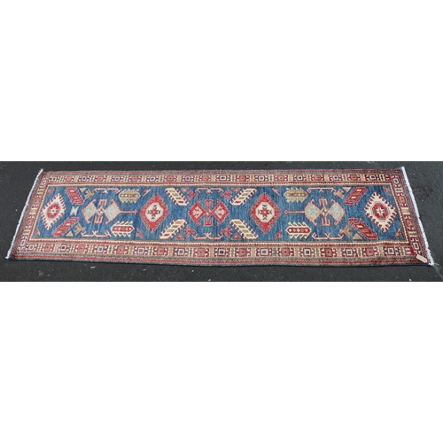 628 - Caucasian style runner, the geometric designs on a blue ground within conforming polychrome border, ... 