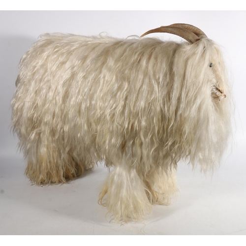 606 - European stool in the form of a goat with white goat hair and horns, H57cm, L73cm.