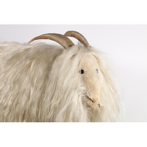 606 - European stool in the form of a goat with white goat hair and horns, H57cm, L73cm.