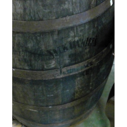 602 - A Jack Daniels no.7 Whiskey coopered metal bound barrel, inset to the top with copper coins, H89cm