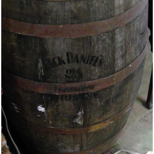 602 - A Jack Daniels no.7 Whiskey coopered metal bound barrel, inset to the top with copper coins, H89cm