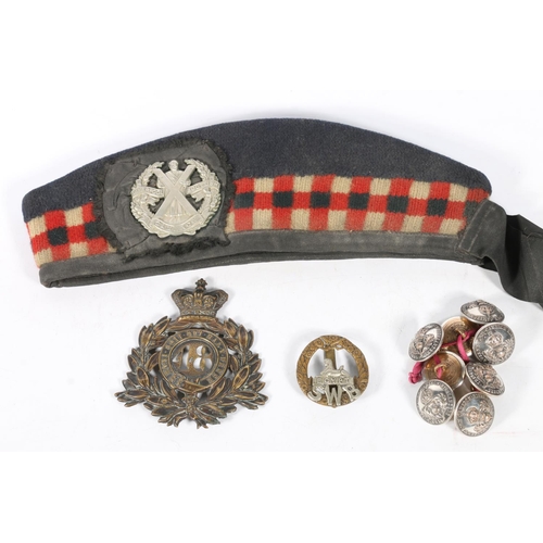 1494 - Helmet plate of the 48th Northampton Regiment, a south Wales Borderers cap badge, a Glengarry with L... 