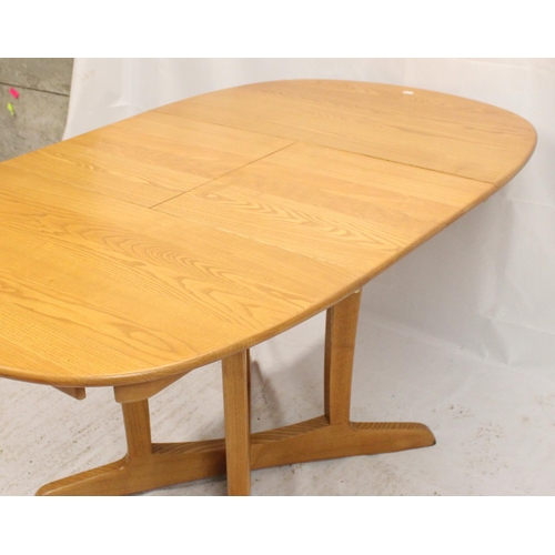 531 - Ercol extending dining table, the oval top on pedestal four leg base, together with four Ercol high ... 