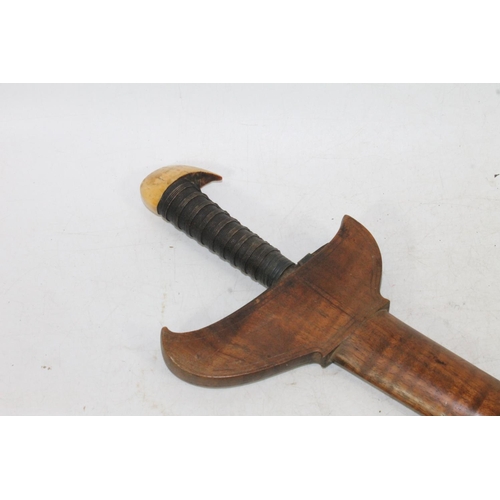 1553 - Malaysian kris with typical ornate flamberge blade, white metal wire bound grip and ivory birds head... 