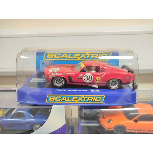 123 - Scalextric. Five 1/32 scale racing car models in perspex cases to include Porsche 997 C2871, Ford Mu... 