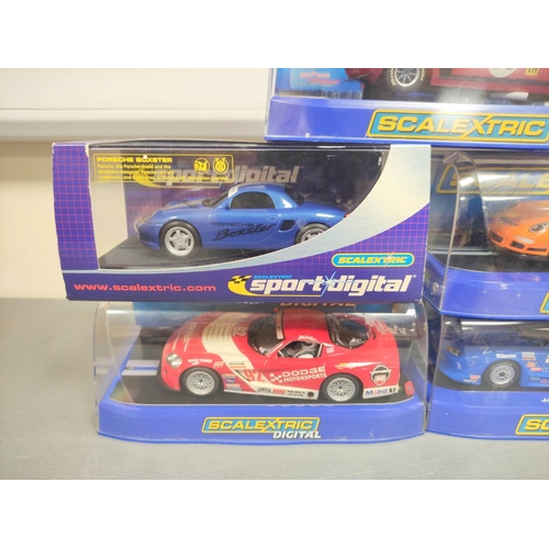 123 - Scalextric. Five 1/32 scale racing car models in perspex cases to include Porsche 997 C2871, Ford Mu... 