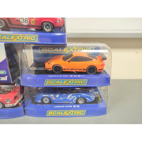 123 - Scalextric. Five 1/32 scale racing car models in perspex cases to include Porsche 997 C2871, Ford Mu... 