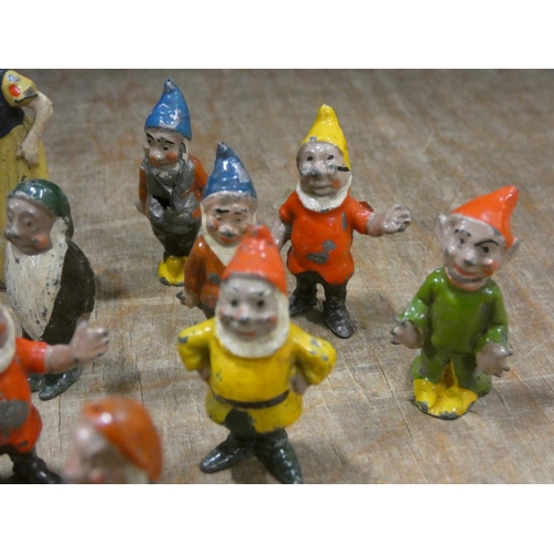 32 - Vintage tin plate toy, boy on a tricycle and a diecast Snow White and the dwarfs group.