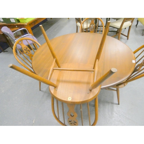 374 - Ercol dining table and four Windsor style chairs. (5)