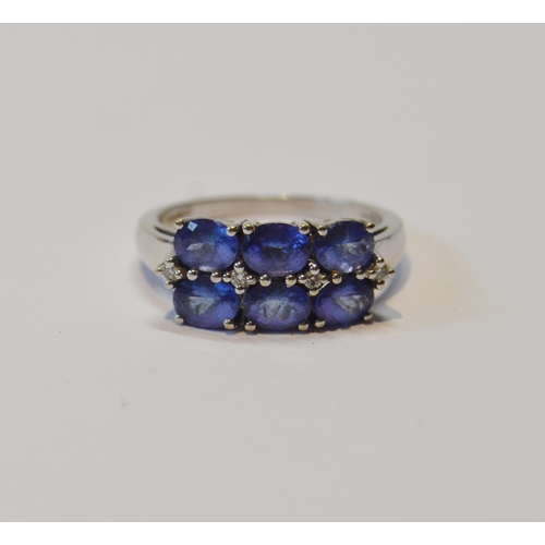 83 - Tanzanite six-stone ring with tiny diamond brilliants, in 18ct white gold, size O½, 5.1g gross.