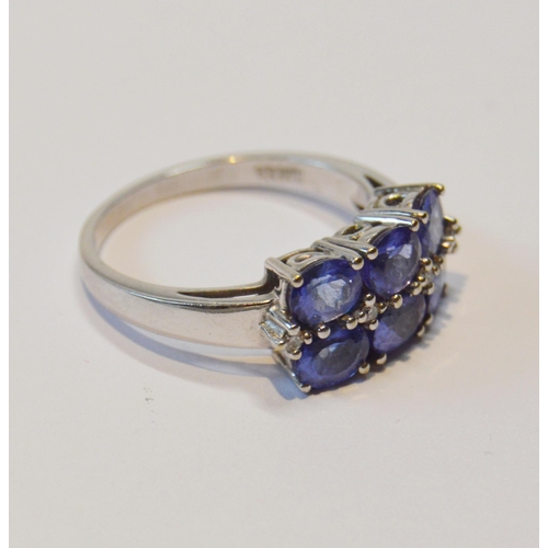 83 - Tanzanite six-stone ring with tiny diamond brilliants, in 18ct white gold, size O½, 5.1g gross.