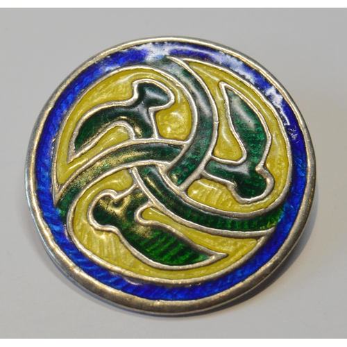 93 - Ian McCormack of IonaIona silver circular brooch in blue, yellow and green enamels, 34mm, and three ... 