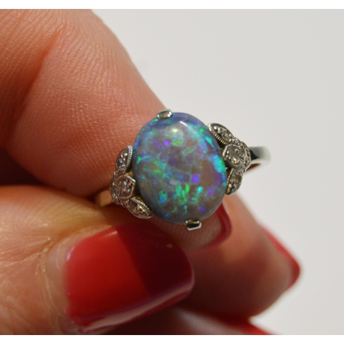 94 - Art Deco period black opal and diamond ring, the cabochon approximately 10mm x 8mm, in trefoil shoul... 