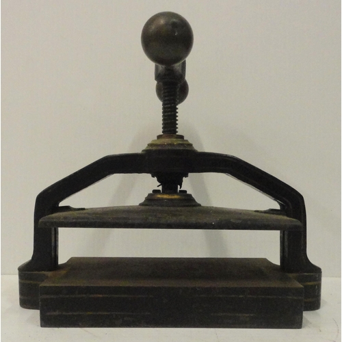 207 - Victorian cast iron book press, with lion seal mark to the underside, 41cm high and 52cm wide.