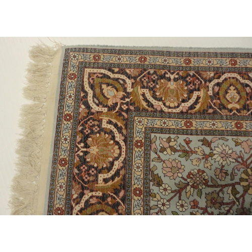 383 - Kashmir silk rug with all over foliate swags and medallions, blue and beige field to the centre, cre... 