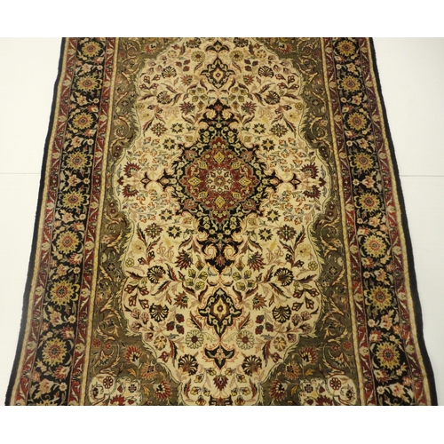 384 - Kashmir silk rug with foliate medallion to the centre, on cream, red and blue field within all over ... 