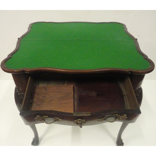 412 - George II style mahogany fold-over card table, on twin gate supports with central drawer, on ball an... 