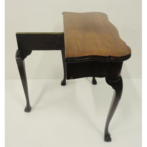 412 - George II style mahogany fold-over card table, on twin gate supports with central drawer, on ball an... 