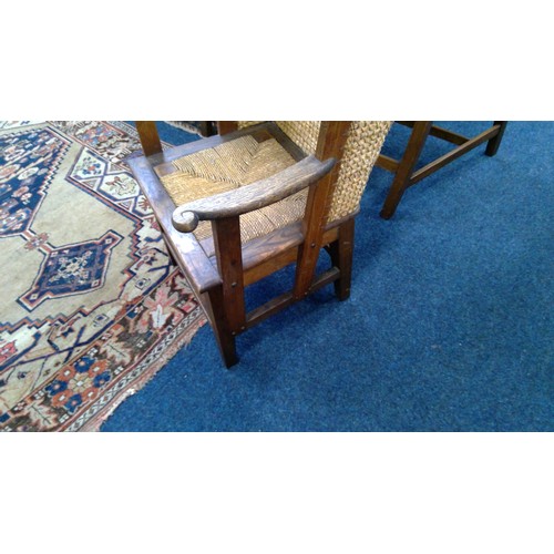 598 - Early 20th century oak framed Orkney chair, the woven back with scrolled arms and drop in woven seat... 